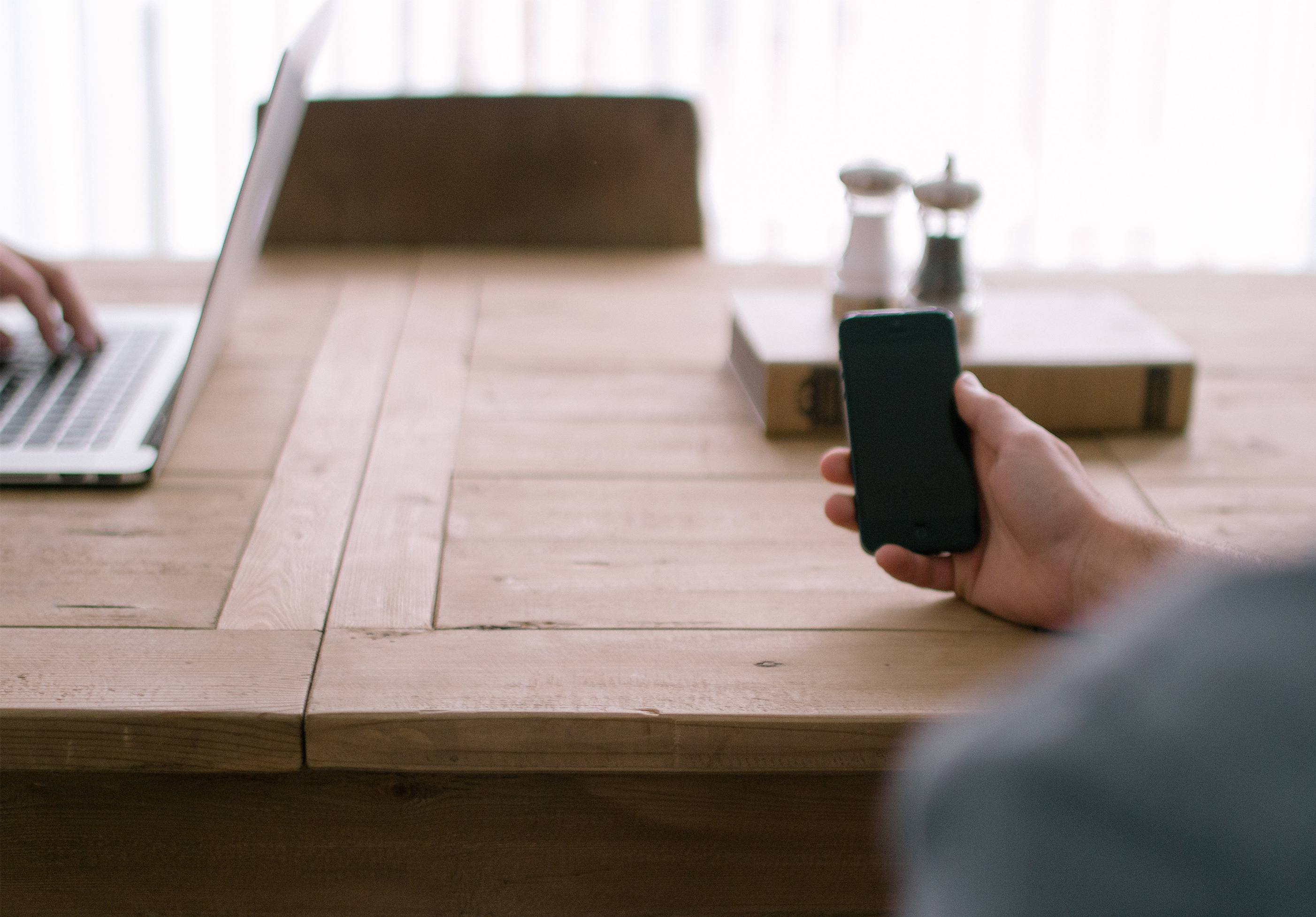 at younity we use mobile phones and sit at tables doing important things on computers to better the world younity office